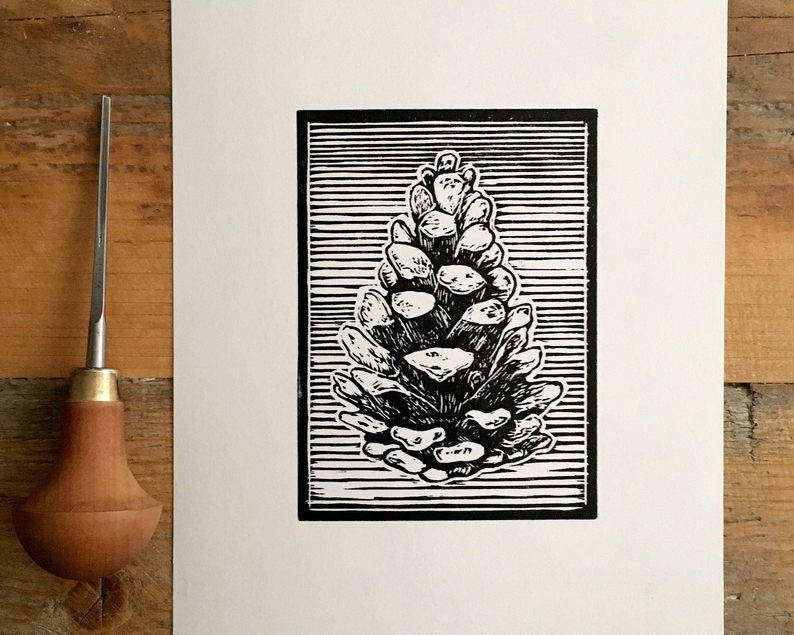 Pine cone linocut with carving tool